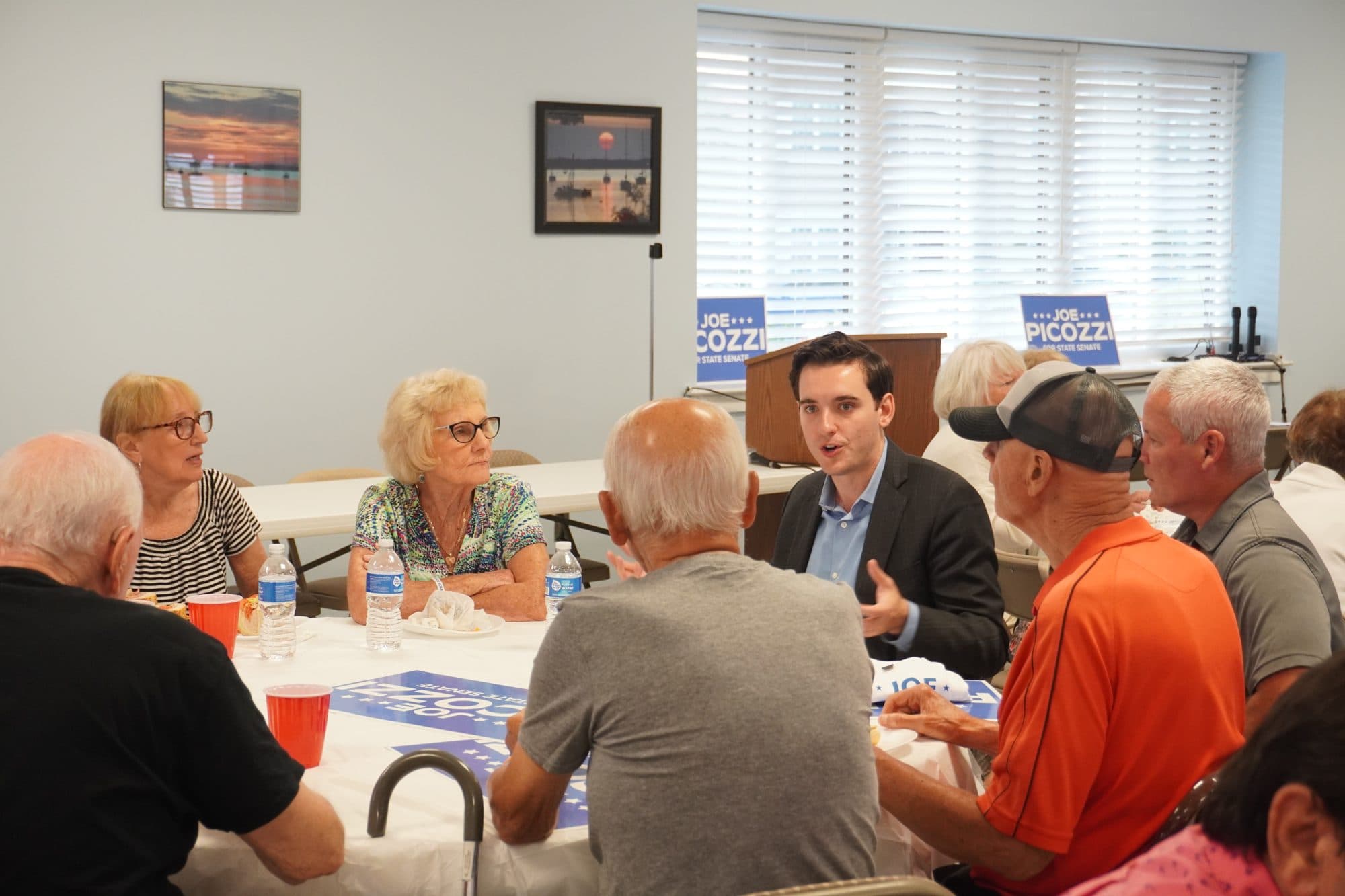 Joe talking with neighbors at a community meeting